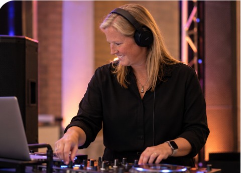 Bex mixing music at the DJ table